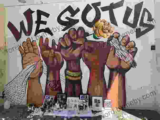 A Black And White Photograph Of A Group Of People Standing In Front Of A Wall Covered In Graffiti With Messages Of Protest And Resistance. Rise Up The Art Of Protest